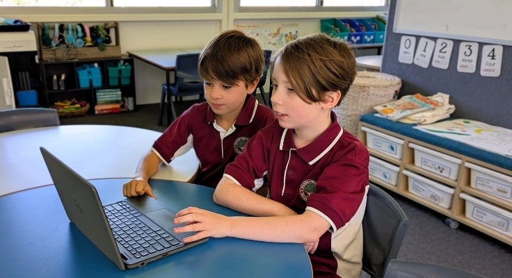 Students working on a laptop in the classroom